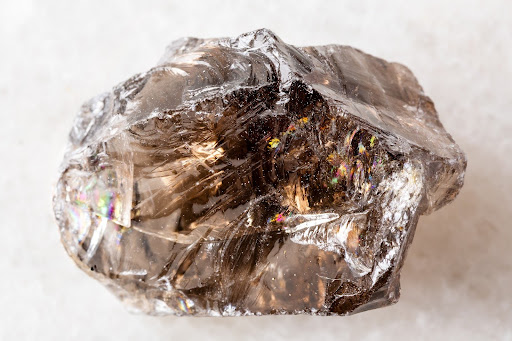A large, raw, ethically sourced smoky quartz crystal with natural inclusions.