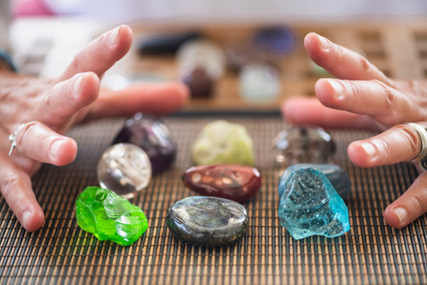 A collection of polished and tumbled stones on a bamboo mat
