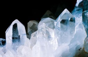 Close-up of clear quartz crystal cluster points against a black background, showing transparency, surface condition, and structural formation used in wholesale bulk evaluation