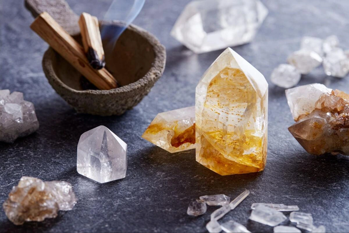 Citrine and Quartz Points on Slate Citrine and clear quartz points arranged with palo santo sticks on dark slate